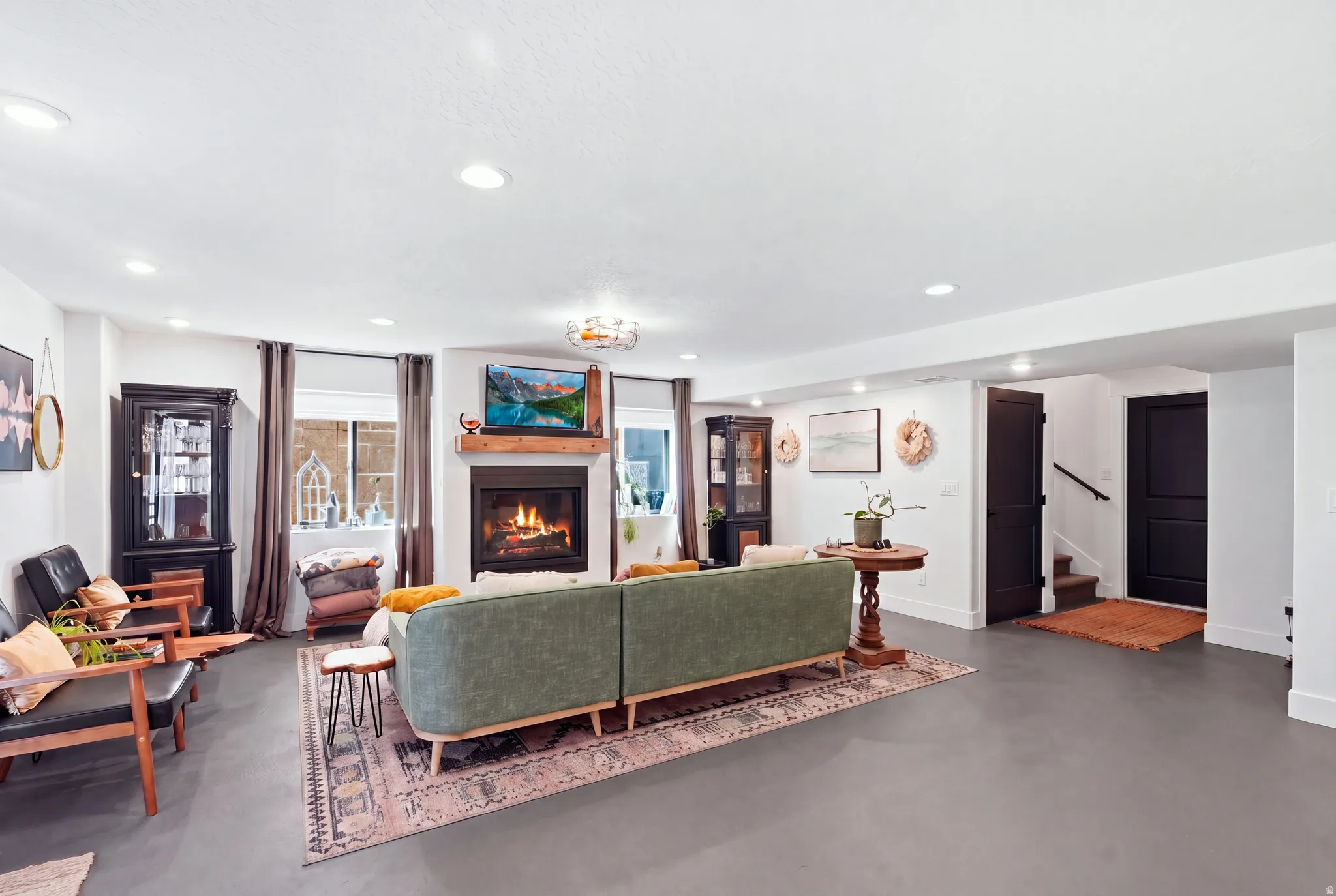 Recessed lighting, wood-finish flooring, and a fireplace with a wood mantle