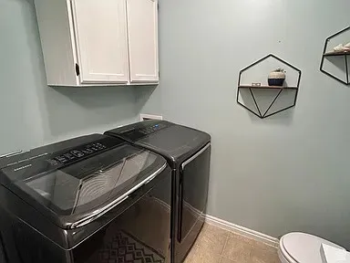 White upper cabinetry provides storage