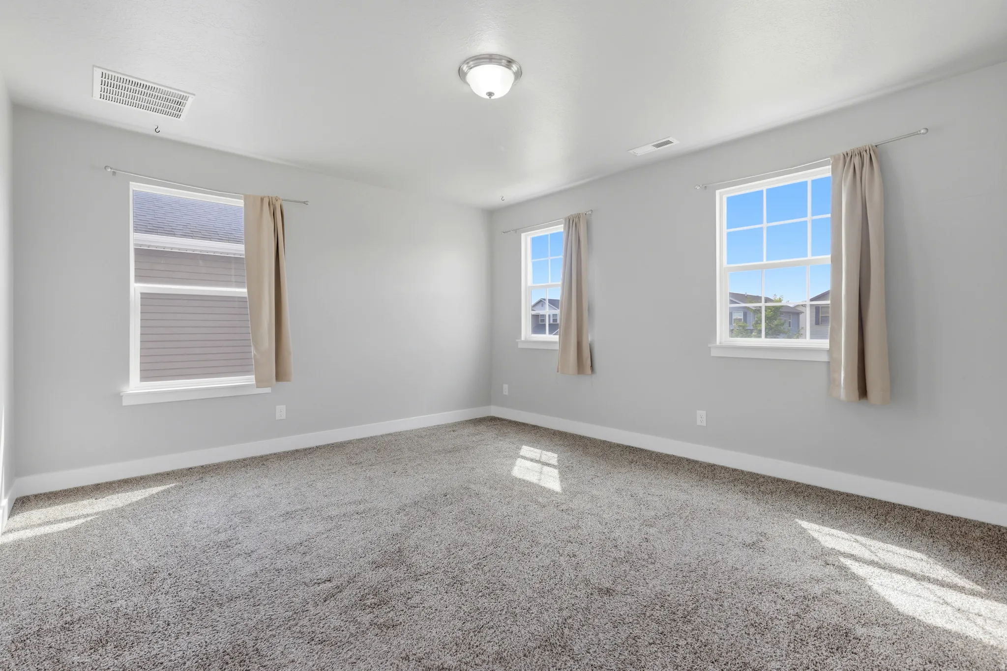 Plush gray carpeting, white trim, and light gray walls