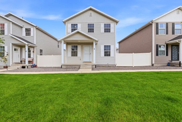 Two-story exterior with light-toned siding, white trim, and a covered entry