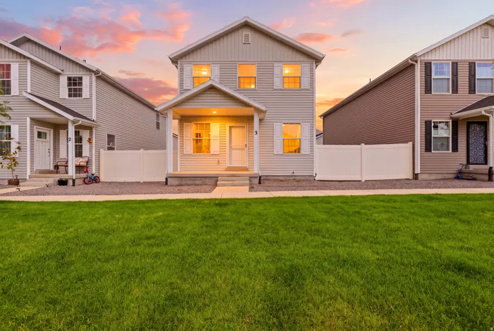 Two-story residence featuring light-colored siding and a covered front porch