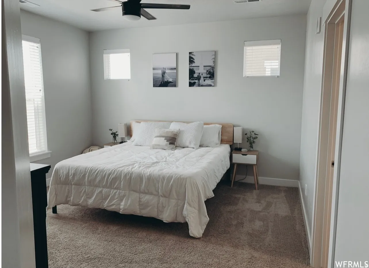 Recessed lighting, ceiling fan, carpet flooring, and multiple windows with blinds