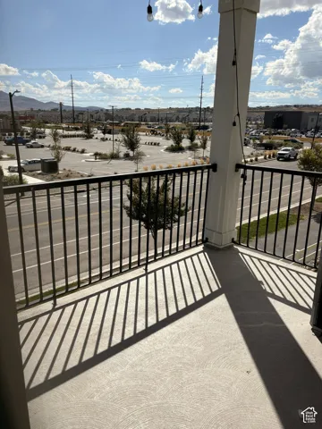 Balcony with a black metal railing and a textured concrete floor