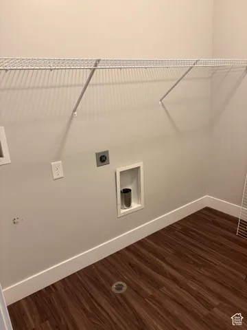 Wood-finish flooring with floor drain, wire shelving, and utility hookups
