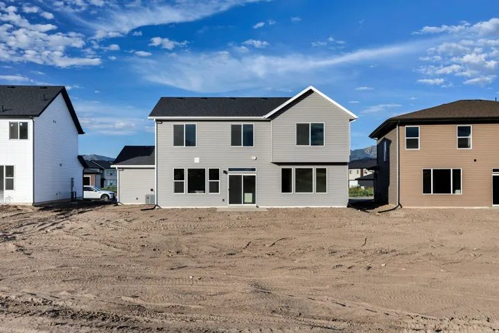 Modern two-story residence featuring light gray siding and a dark shingle roof