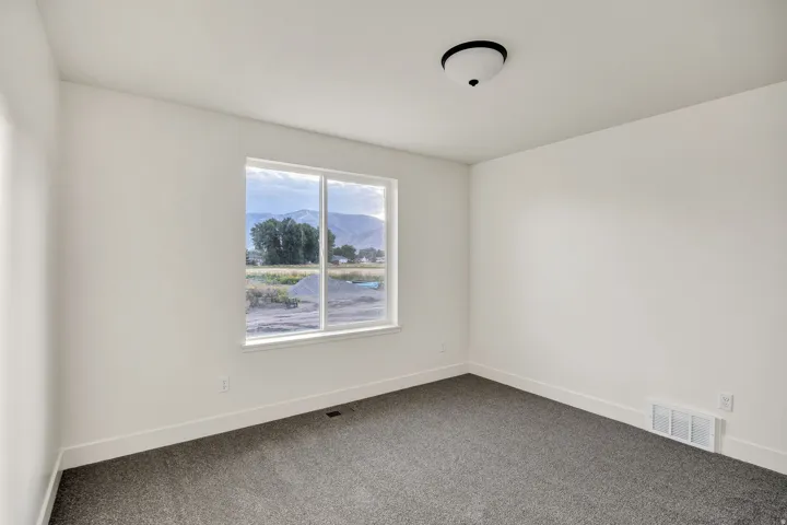 Neutral color palette with dark gray carpeting