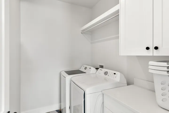 White wall-mounted cabinetry, integrated countertop, and built-in shelving