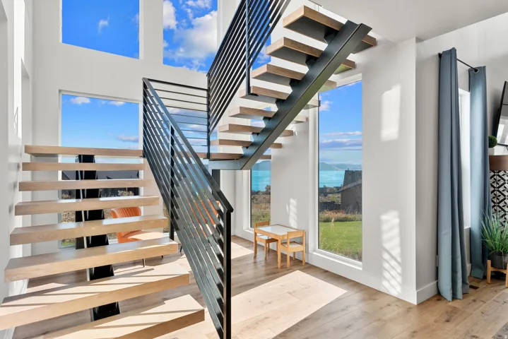 Floating staircase with wood-finish treads and black metal railings