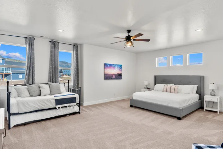 Recessed lighting, ceiling fan, and multiple windows creating a bright atmosphere