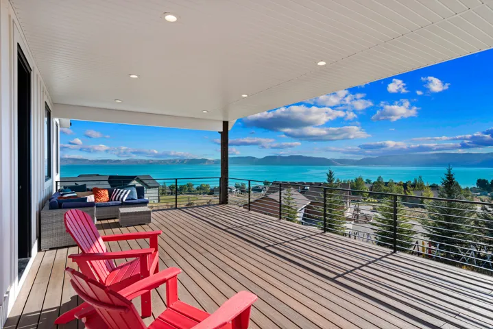 Expansive covered deck featuring recessed lighting, composite decking, and cable railings