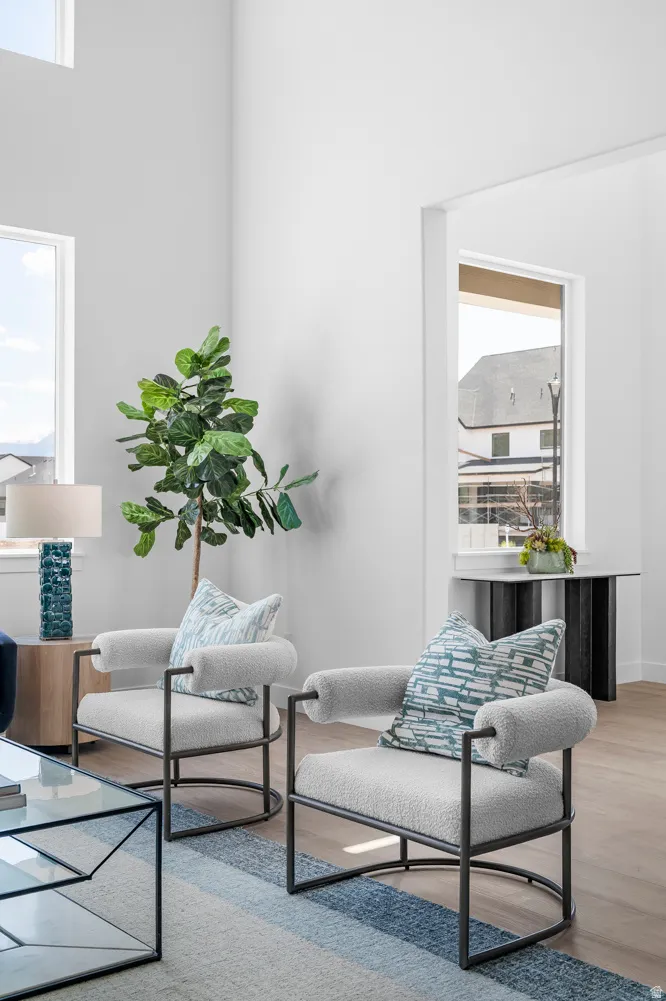 High ceilings, light wood-finish flooring, and multiple windows create an airy atmosphere