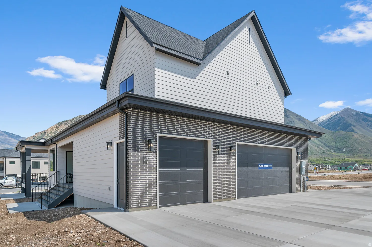 Contemporary exterior featuring gray brick and light-colored siding