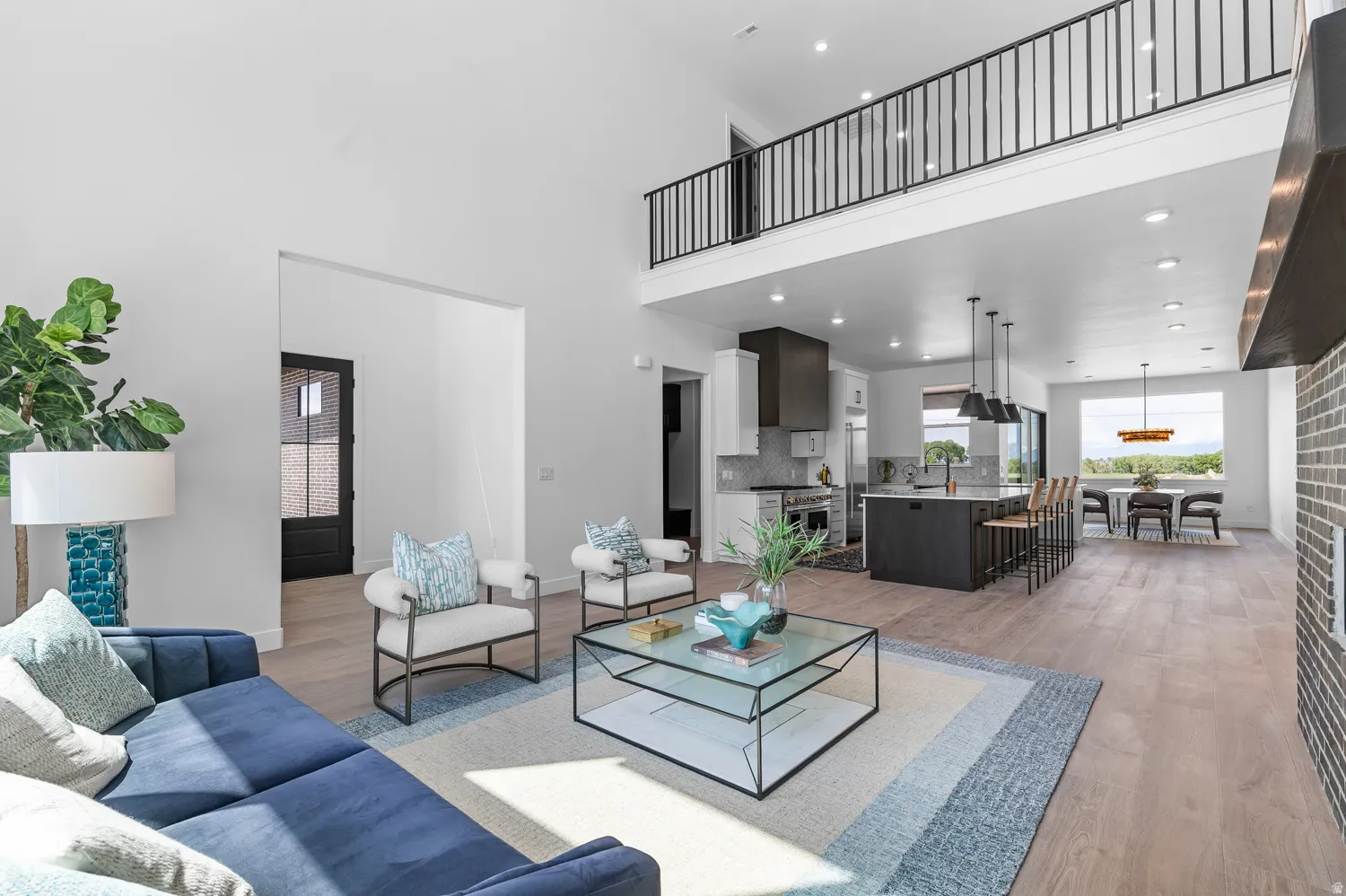 High ceilings with an open-concept living area, featuring wood-finish flooring