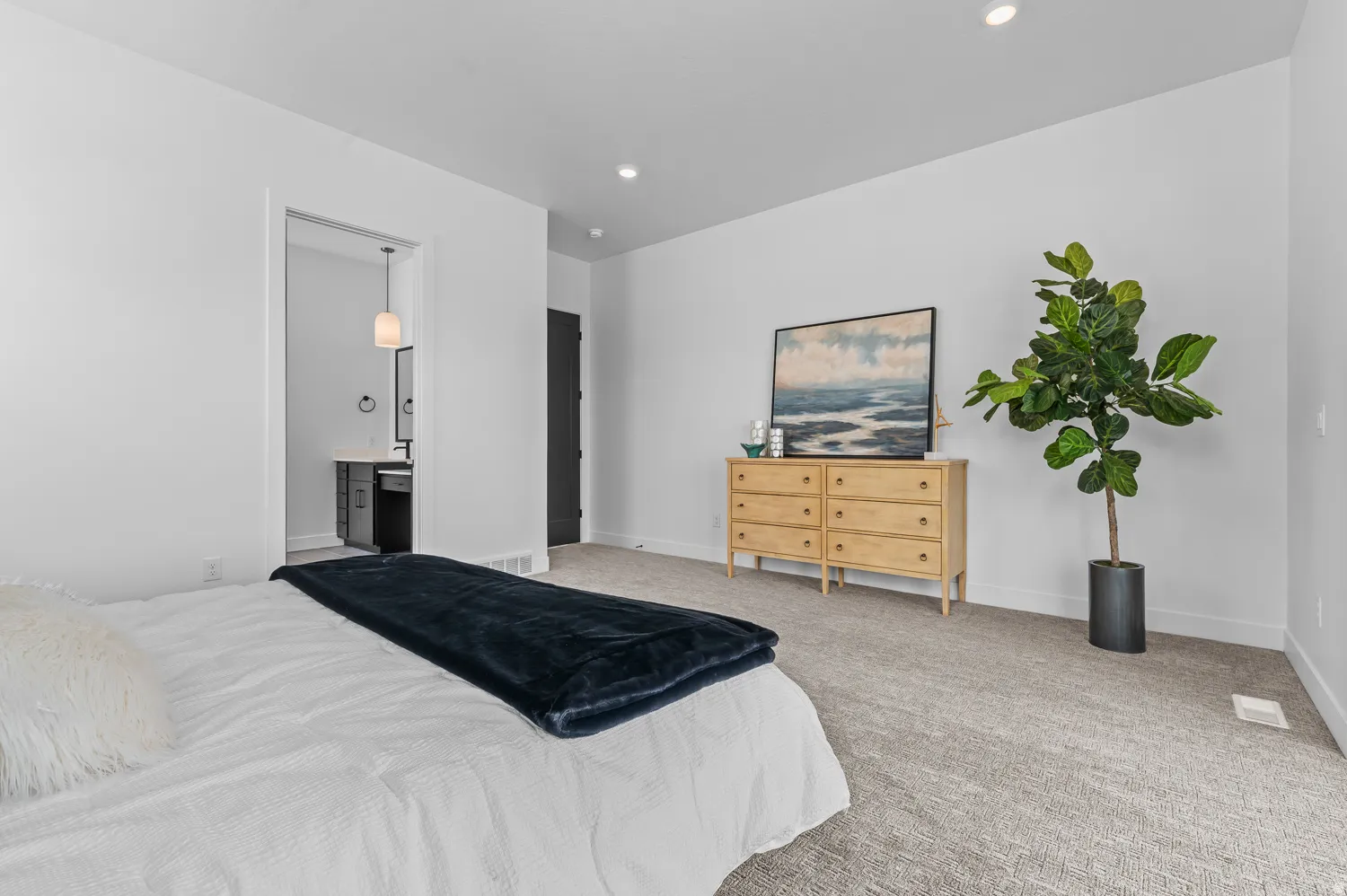 Plush carpet flooring, recessed lighting, and a dark-paneled door