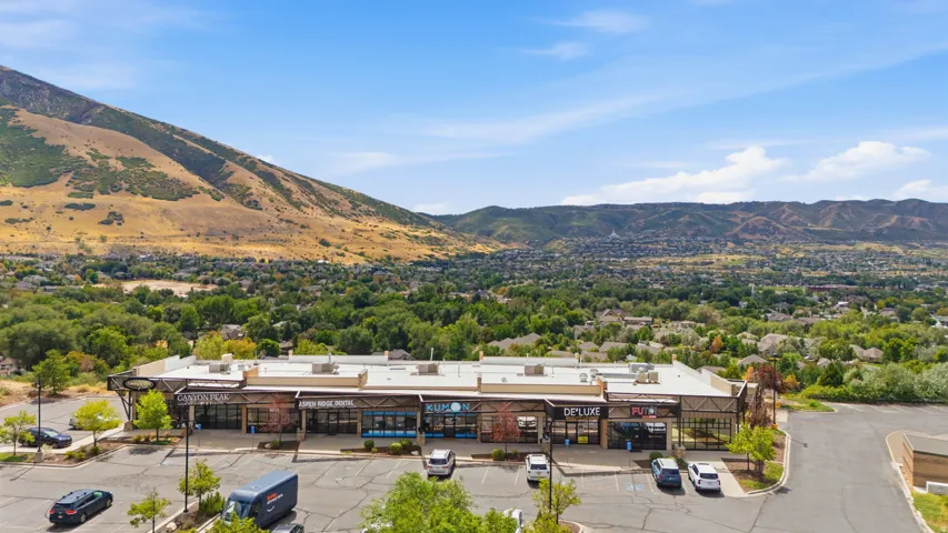 Commercial building with multiple storefronts and a paved parking lot