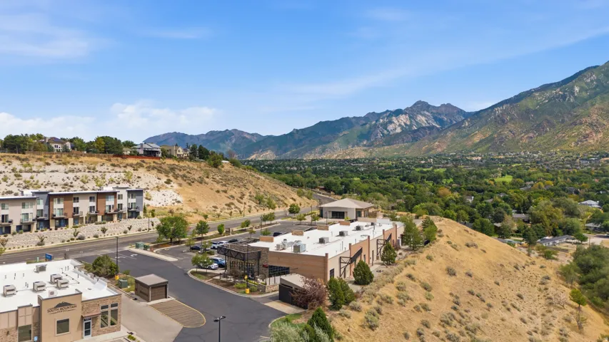 Terraced residential buildings with contemporary architecture, surrounded by natural mountainous terrain