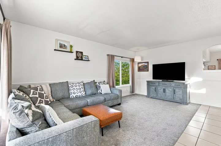 Recessed lighting, wood-trim wainscoting, and carpeted flooring