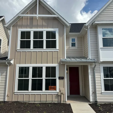 Two-story residence featuring a red entry door, board and batten siding, horizontal siding, and white window frames