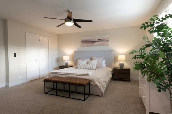 Recessed lighting, ceiling fan with integrated lighting, window with white plantation shutters, built-in closet with bifold doors, and neutral carpet flooring