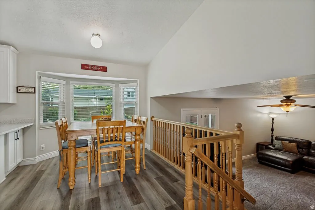 Dining area with bay windows, wood-finish flooring, and built-in cabinetry
