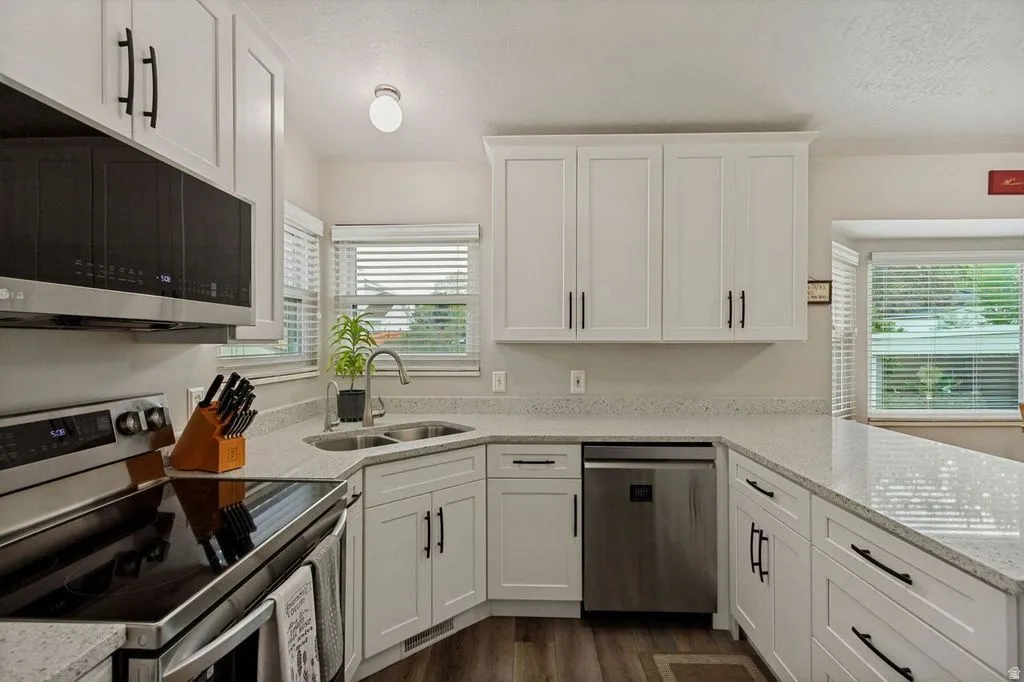 White shaker-style cabinetry with matte black hardware