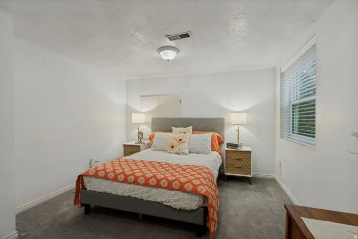 Wall-to-wall carpeting and white walls