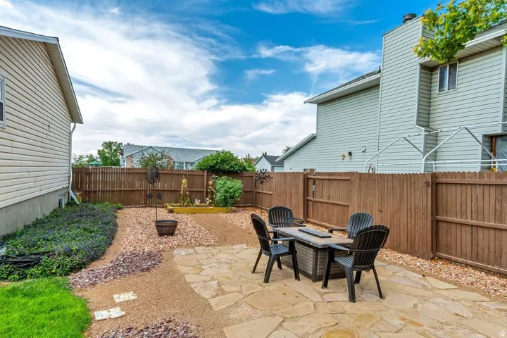 Patio area with flagstone pavers, surrounded by gravel landscaping