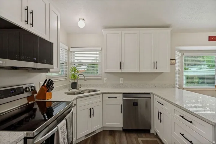 White shaker-style cabinetry with matte black hardware