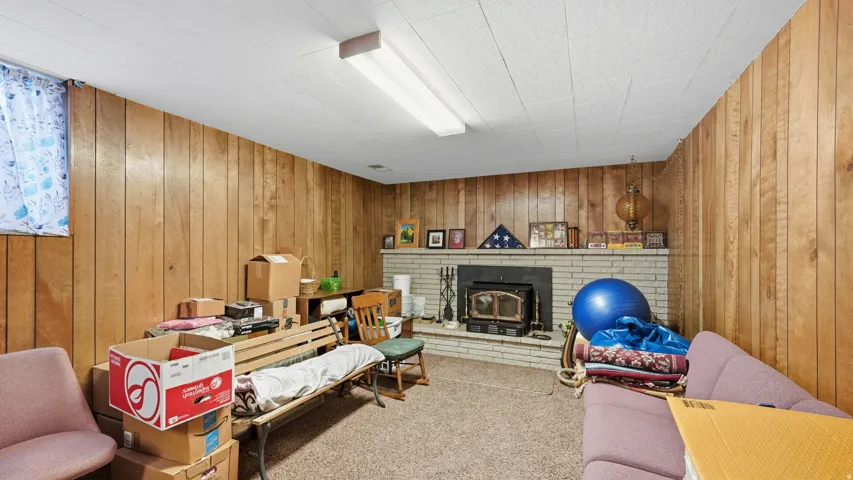 Family Room with wood burning stove and paneling.