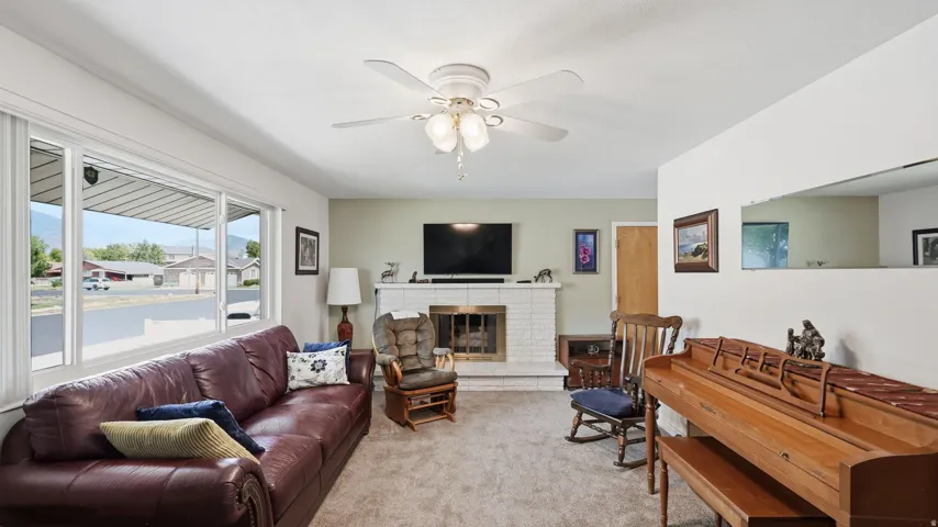 White brick fireplace with a brass-finish insert