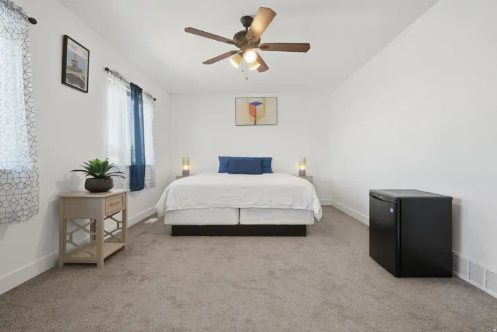 White walls and ceiling fan with wood-finish blades