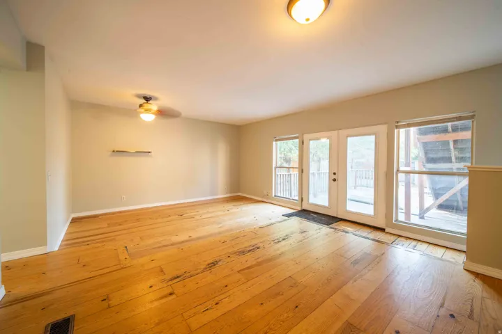 Hardwood flooring, ceiling fan with integrated lighting, recessed overhead lighting, French patio doors, and large windows