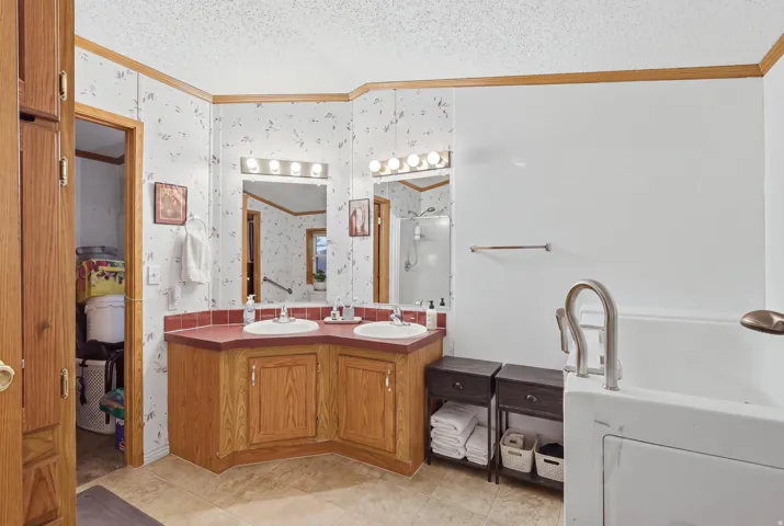 Dual vanity with white undermount sinks and wood cabinetry