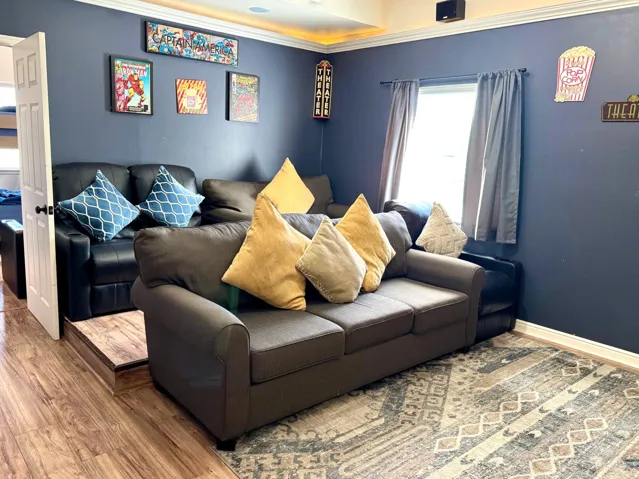 Wood-finish flooring throughout, with a window featuring privacy coverings