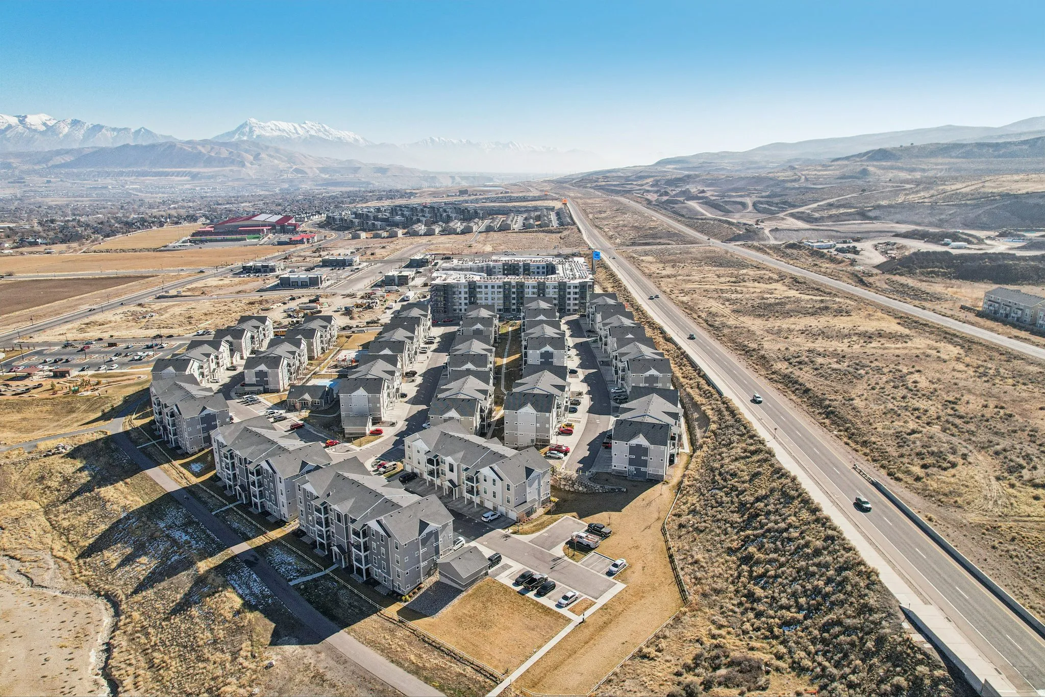 Modern multi-story residential buildings featuring gabled roofs and private balconies