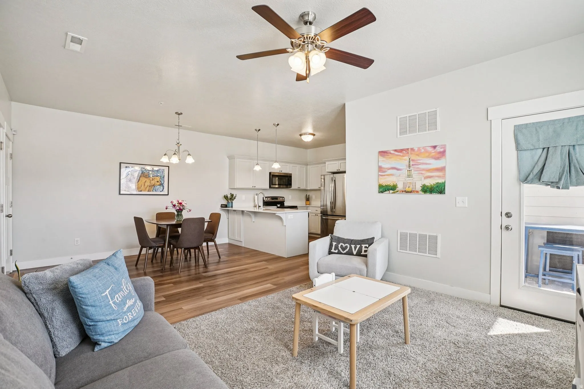 Recessed ceiling lighting, wood-finish flooring, and a ceiling fan with integrated lighting