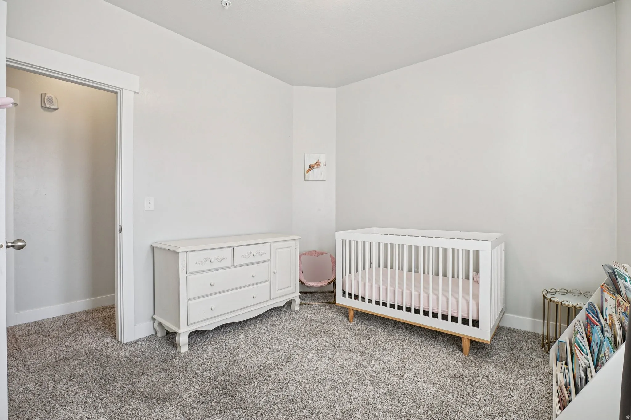 Recessed lighting, carpeted flooring, and a white interior door with polished nickel hardware