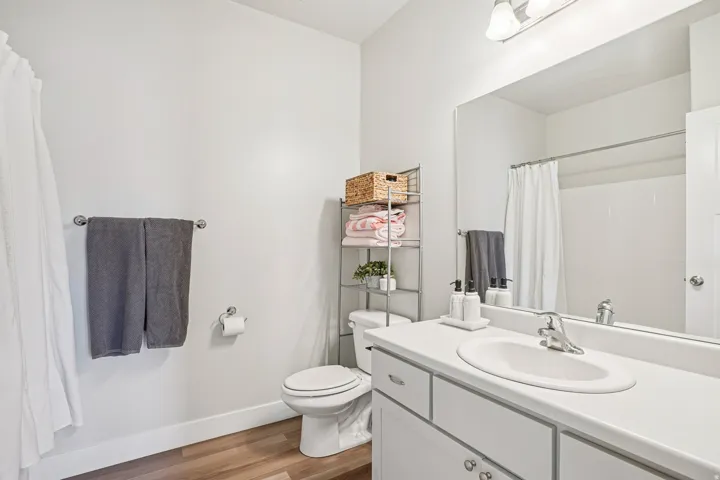 Bathroom featuring a vanity with an integrated sink, polished chrome faucet, and a large mirror