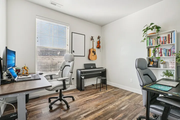 Recessed lighting, wood-finish flooring, white walls, and a window with blinds