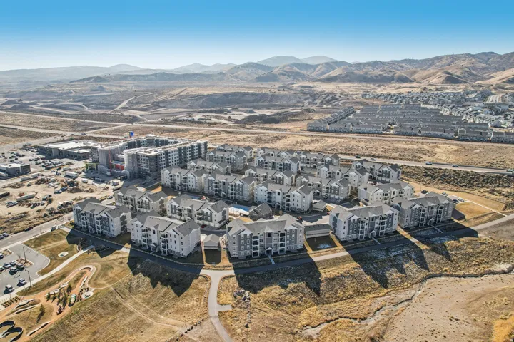 Newly constructed multi-story buildings featuring balconies and a consistent exterior facade