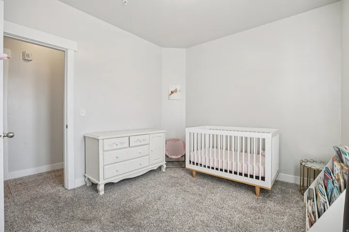 Recessed lighting, carpeted flooring, and a white interior door with polished nickel hardware