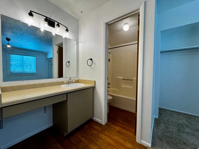 Vanity with built-in cabinetry, vessel sink, and an integrated countertop