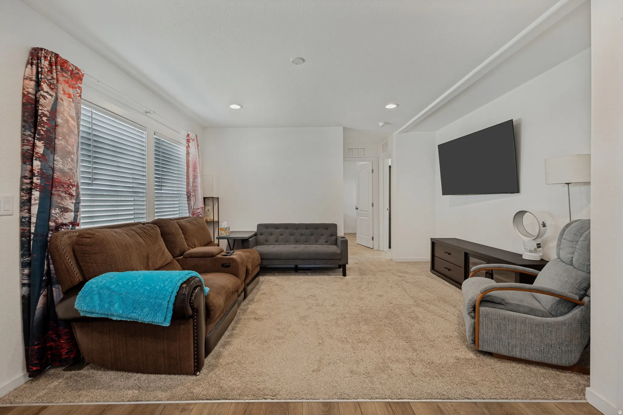 Recessed lighting, white walls, wood-finish flooring, and wall-to-wall carpeting