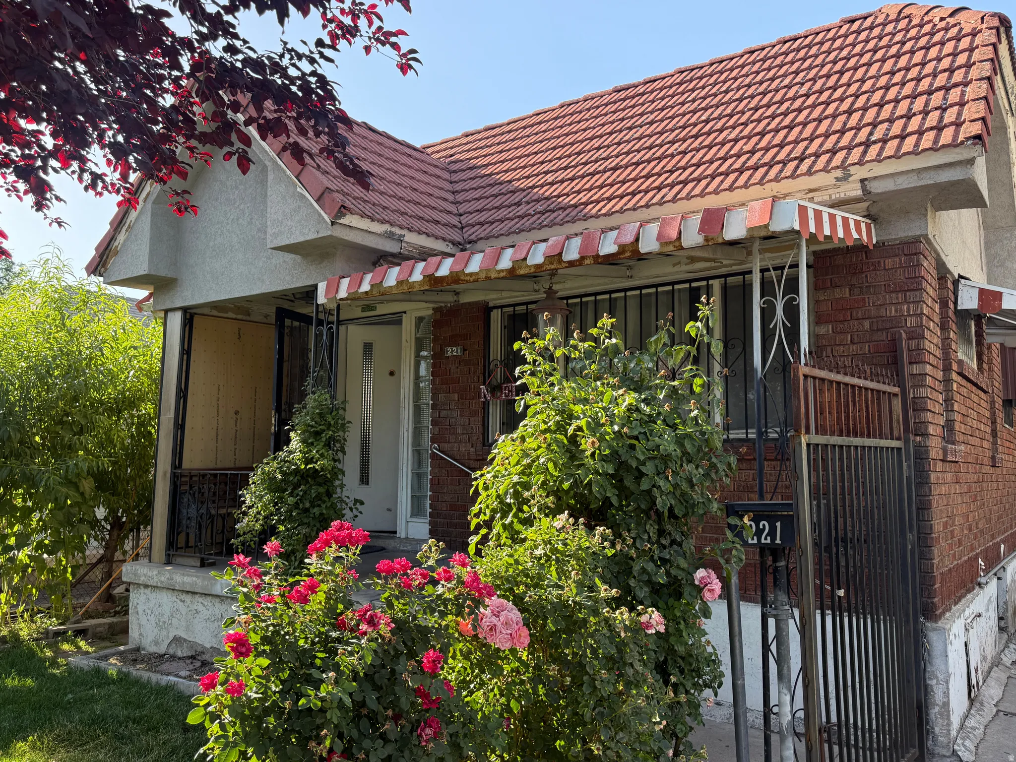 Brick exterior with a red tile roof and a covered porch