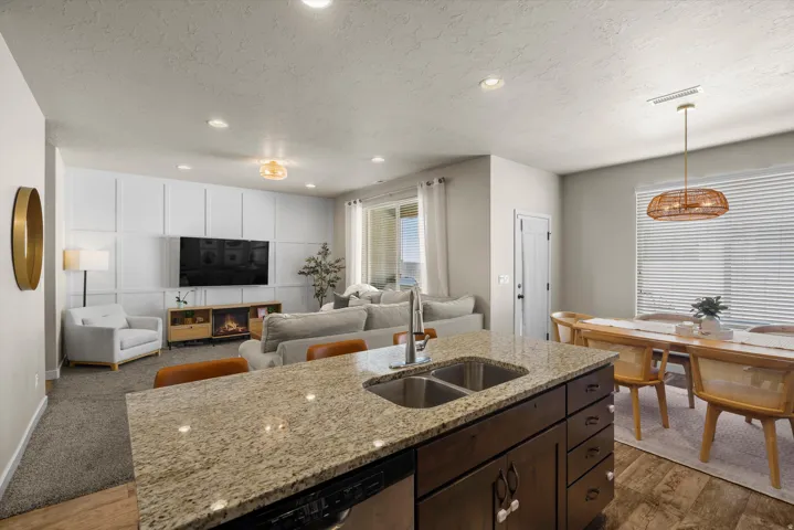 Kitchen island with a granite-style countertop and undermount double-basin sink