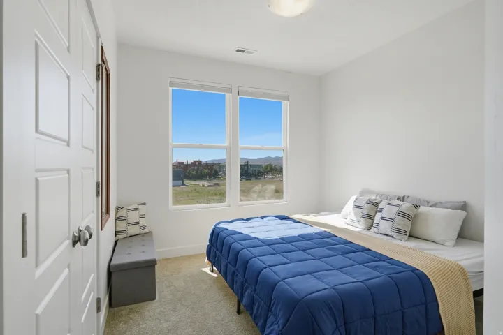 Recessed window with expansive outdoor scenery, wall-to-wall carpeting, and bright overhead lighting