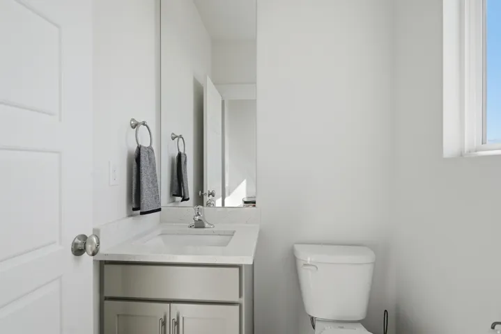 Vanity with integrated sink, light-toned countertop, and undermount cabinetry