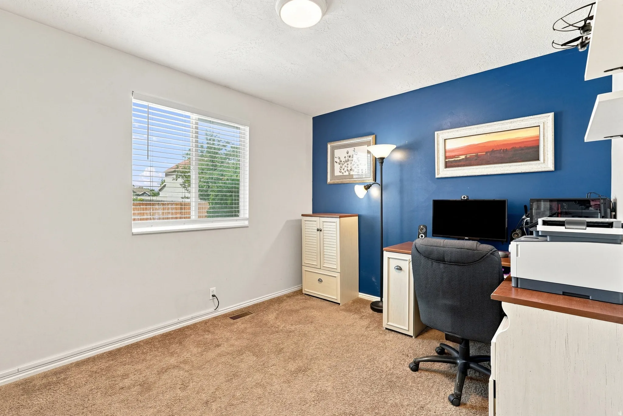 Wall-to-wall carpeting with a window and horizontal blinds