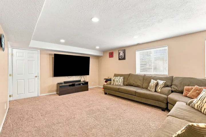 Recessed lighting illuminates this expansive carpeted area