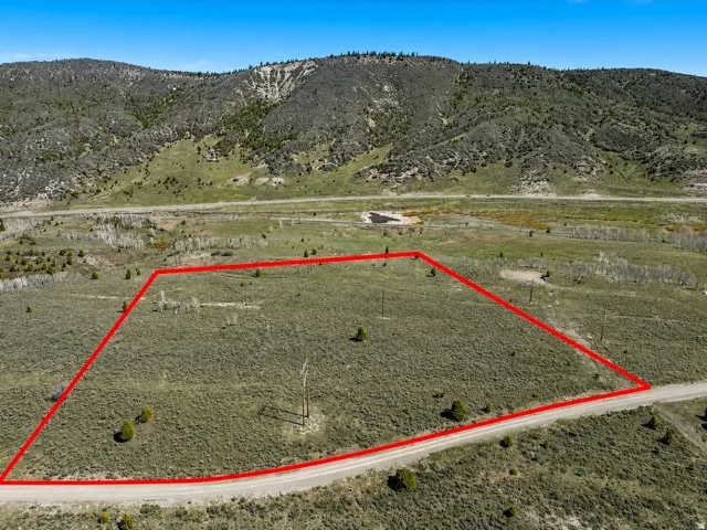 Expansive land parcel with surrounding mountainous terrain